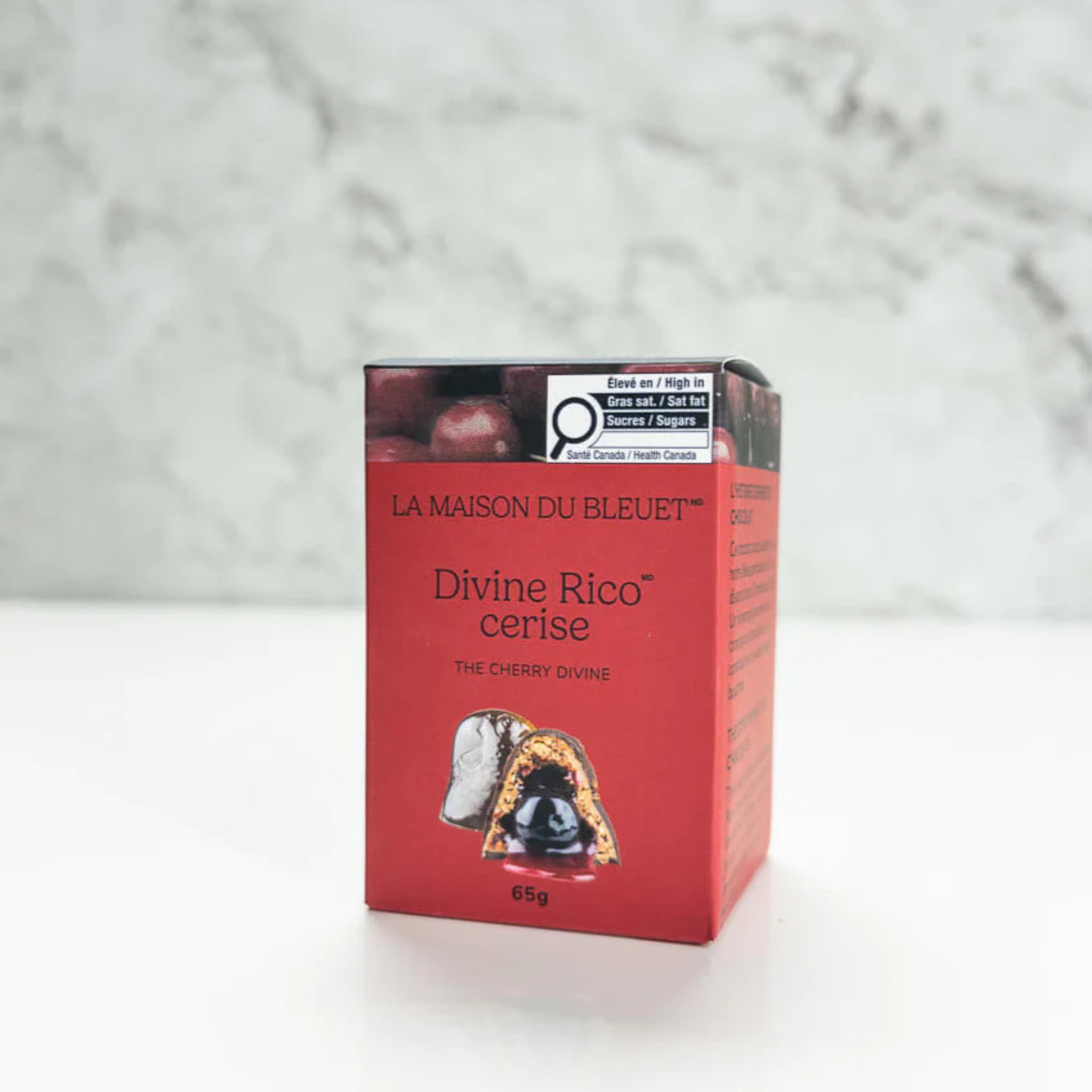 Chocolat Divine aux cerises 65g with Belgian milk chocolate, crunchy hazelnut praline, and amarena cherry ganache